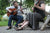 Couple, playing guitars outdoors, wearing Aurora Shoe Co. Handmade Leather Shoes.