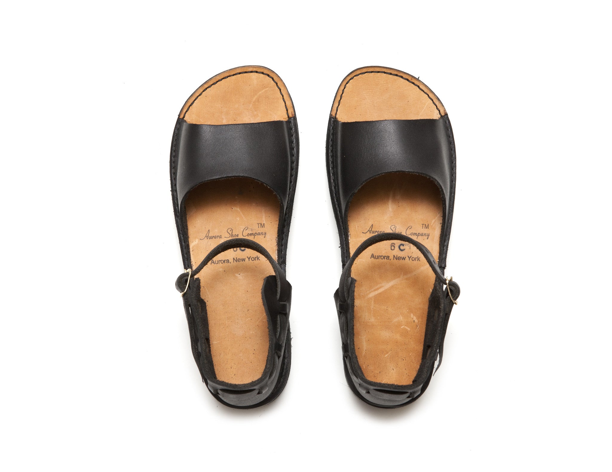 Black New Mexican Handmade Leather sandals by Aurora Shoe Co. - Top down, white background.