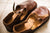 Aurora Shoe Co. Brown T-Strap handmade leather shoes on light colored ceramic floor.   The photo demonstrates the softness of the Horween Chromexcel Leather.