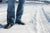 person wearing blue jeans, standing in snow wearing Aurora Shoe Co. Navy Handmade Leather Shoes