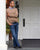 Model standing on the front porch of the Inns of Aurora, wearing Black Middle English handmade leather shoes by Aurora Shoe Co.