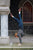 Woman doing handstand against stone pillar, wearing brown North Pacific handmade leather shoes by Aurora Shoe Co.